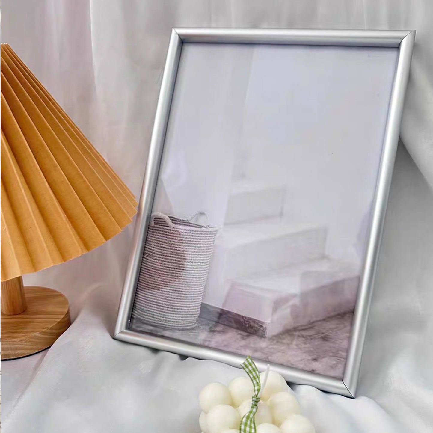 This A4 silver picture frame features a durable aluminium alloy structure with a transparent acrylic front, ensuring your photos or artwork are beautifully displayed while protected.