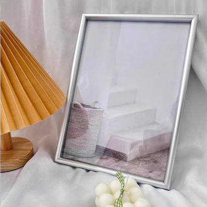 This A4 silver picture frame features a durable aluminium alloy structure with a transparent acrylic front, ensuring your photos or artwork are beautifully displayed while protected. 