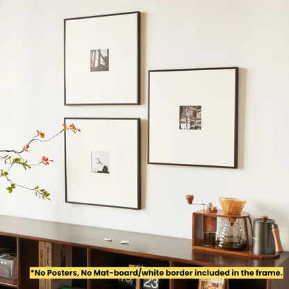 Three framed pictures on a wall above a wooden shelf with a coffee grinder and kettle. SET OF 3 - Thin Aluminum Premium Black Premium Metal Photo Frame 60x60 CM