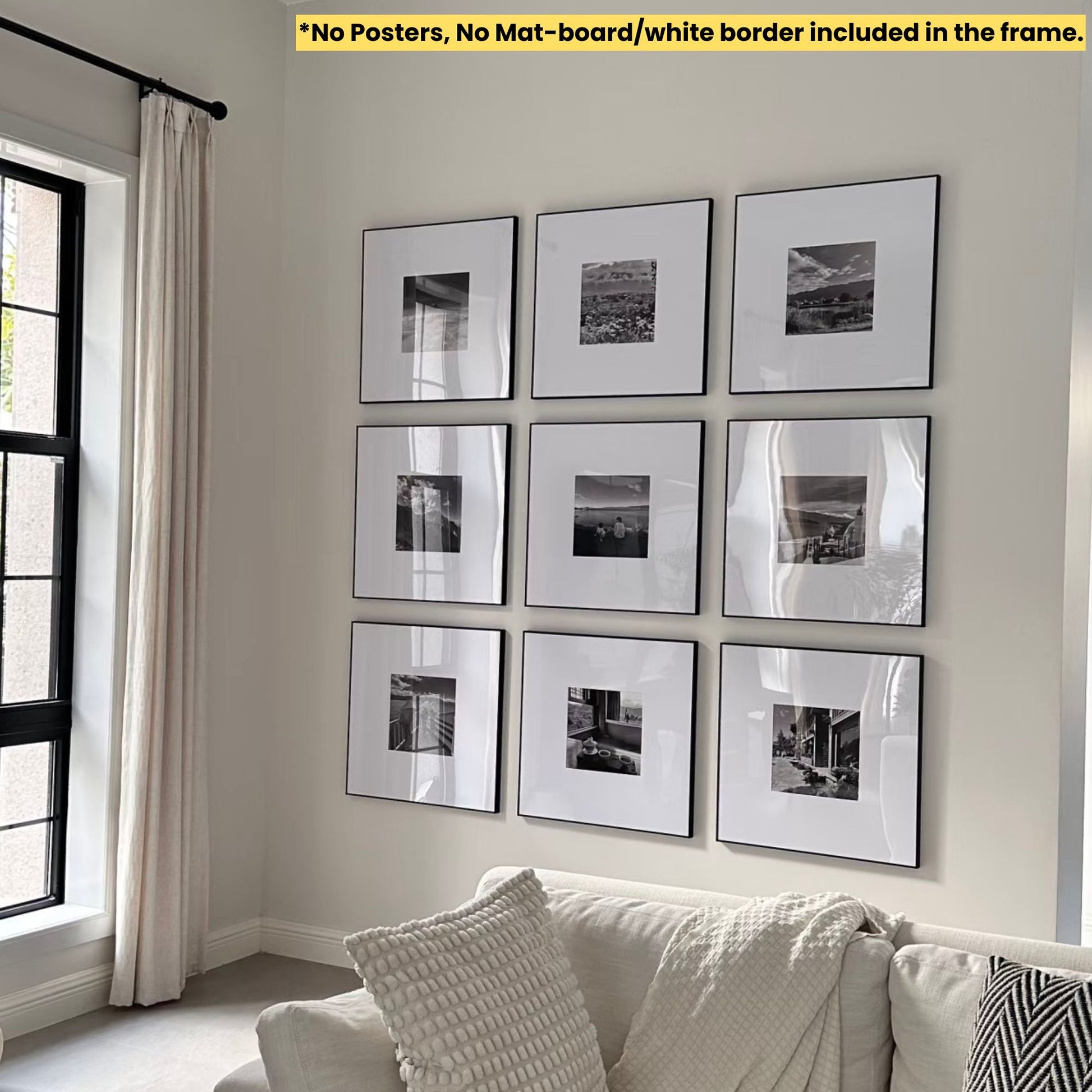Wall with framed black and white pictures above a sofa in a room with a window and curtain.